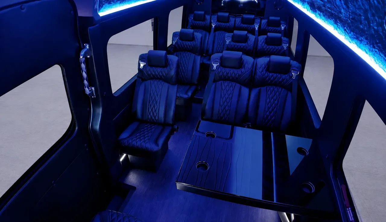 Black Luxury Sprinter Shuttle Van Black Luxury Sprinter Shuttle Van interior with captain's chairs, passenger tables and cup holders for minibus rental