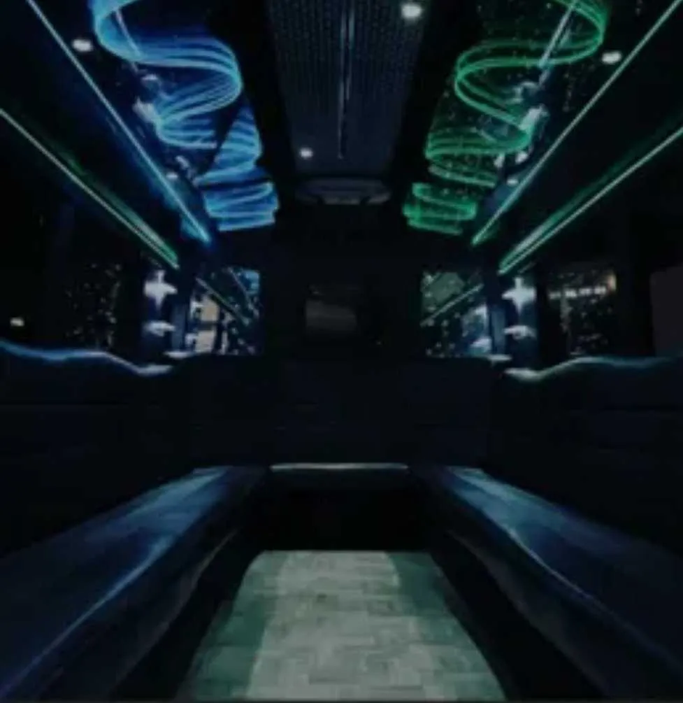 Black Party Bus Black Party Bus interior with perimeter lounge seating and LED accent lighting for party bus rental