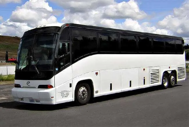 White 30 Passenger Charter Bus with tinted windows for charter bus rental