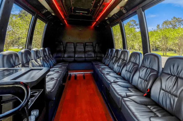 Executive Limousine Bus Executive Limousine Bus interior with perimeter lounge seating and LED ceiling lighting for party bus rental