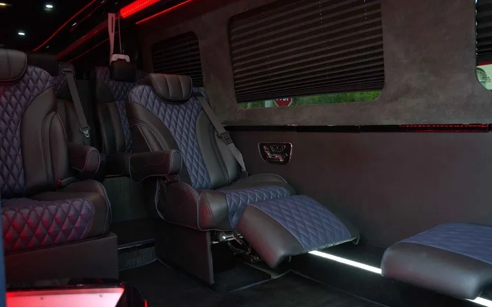 8 Passenger Executive Sprinter Shuttle Van interior with captain's chairs, window shades and LED accent lighting for minibus rental