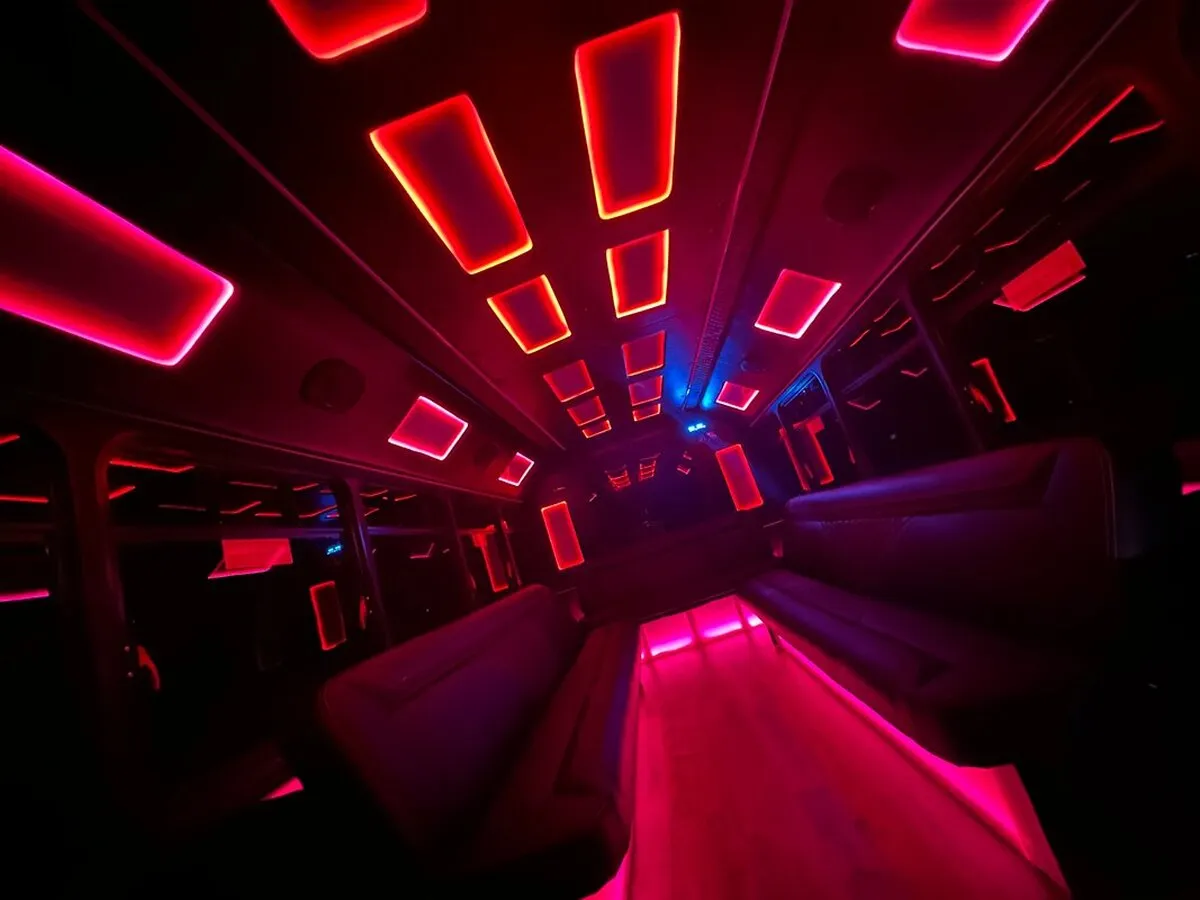 Ford E-450 Series Party Bus interior with LED accent lighting and LED ceiling lighting for party bus rental