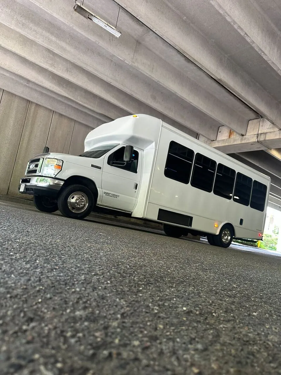 White Ford E-450 Series Party Bus exterior with tinted windows, photo 10 for party bus rental
