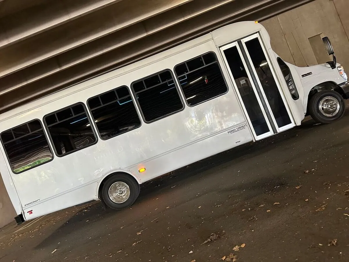 White Ford E-450 Series Party Bus exterior with tinted windows for party bus rental