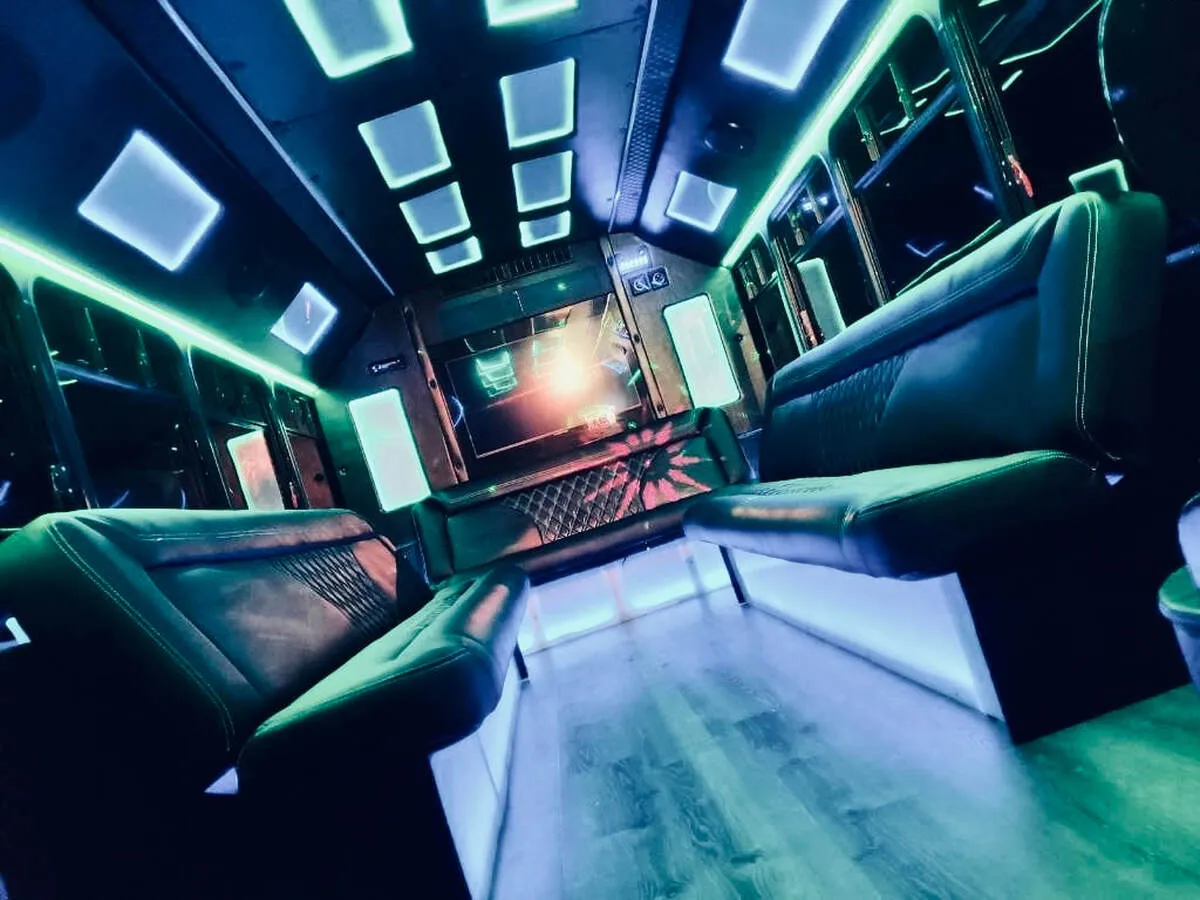 Ford E-450 Series Party Bus interior with perimeter lounge seating, LED accent lighting and LED ceiling lighting, photo 2 for party bus rental