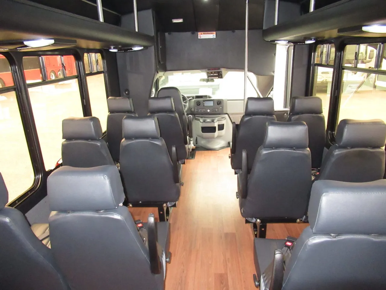 24 Passenger Ford E450 Executive VIP Shuttle Bus interior with wood-look flooring, photo 3 for minibus rental