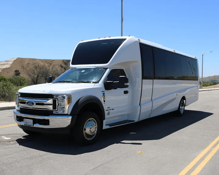 White Ford F550 Executive Mini Coach with tinted windows for minibus rental