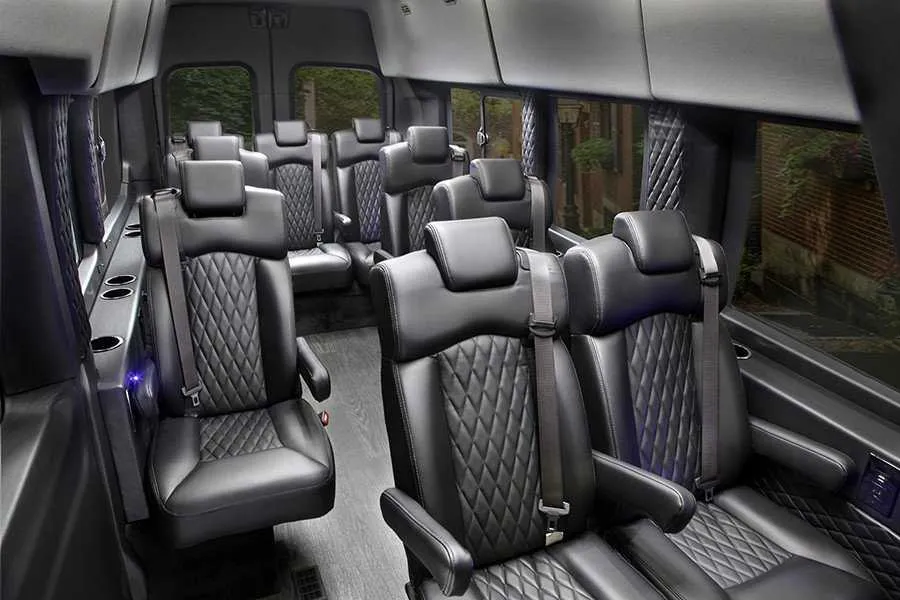 Ford Transit Executive Shuttle interior with captain's chairs and cup holders for minibus rental