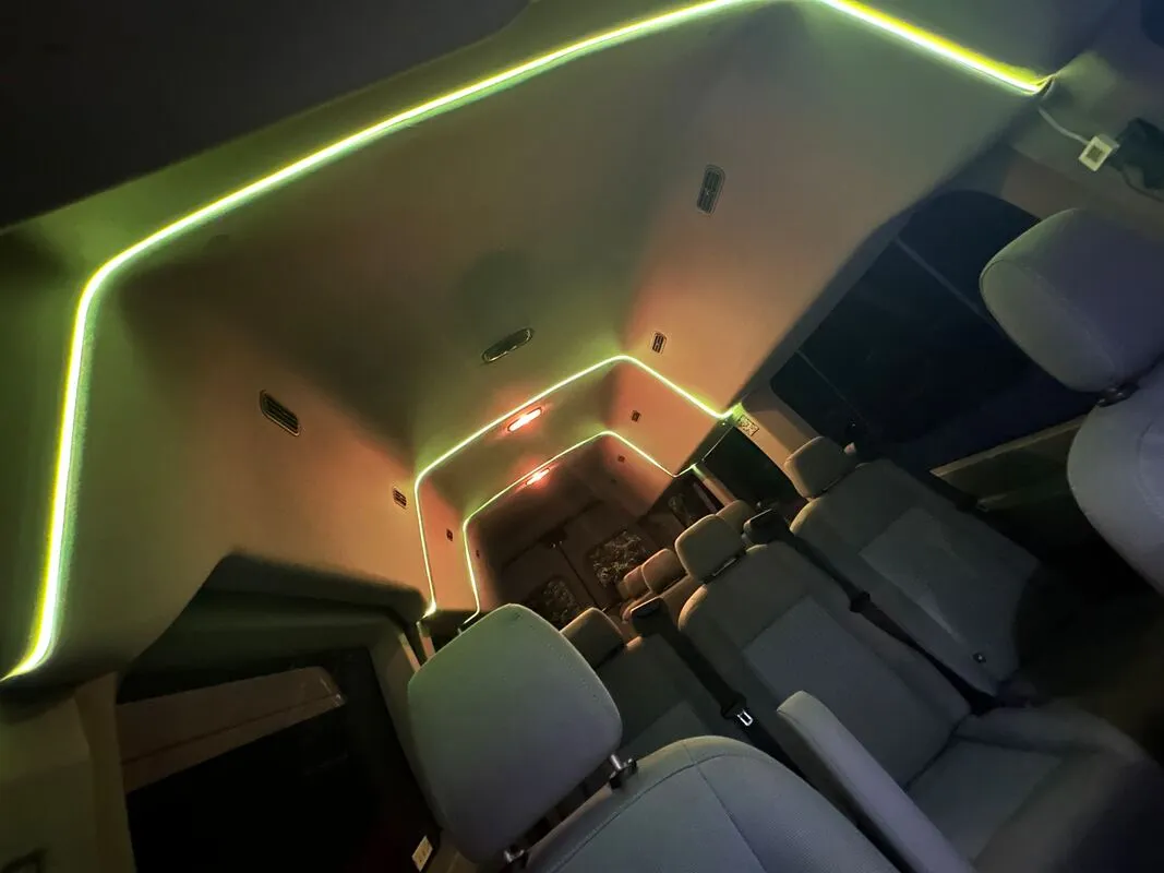 Ford Transit Van interior with high-roof cabin and LED ceiling lighting, photo 4 for minibus rental