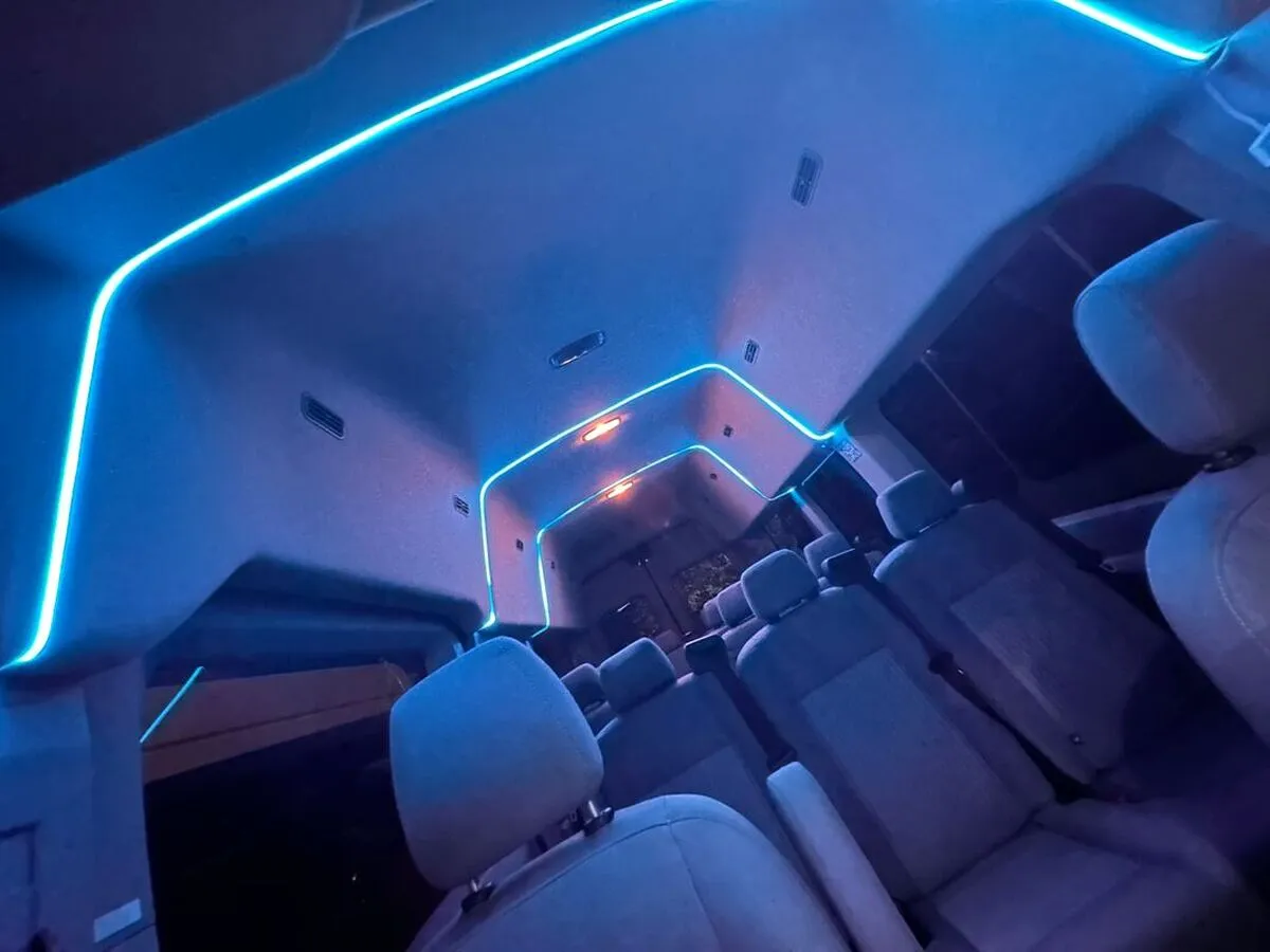 Ford Transit Van Ford Transit Van interior with high-roof cabin and LED ceiling lighting for minibus rental