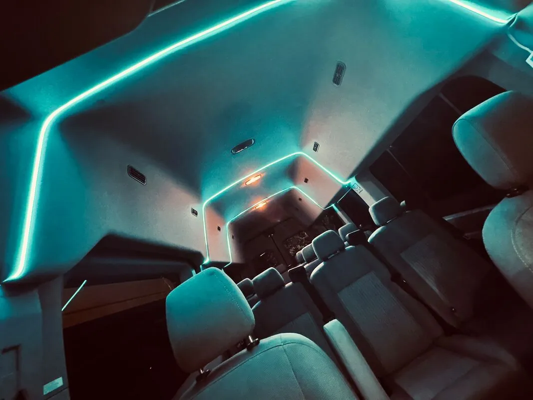 Ford Transit Van interior with high-roof cabin and LED ceiling lighting, photo 2 for minibus rental