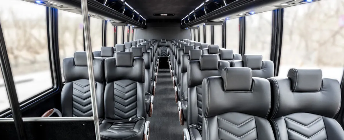 Freightliner 40 Passenger Shuttle Bus (Black) interior with airline-style seats and grab handles and rails for minibus rental