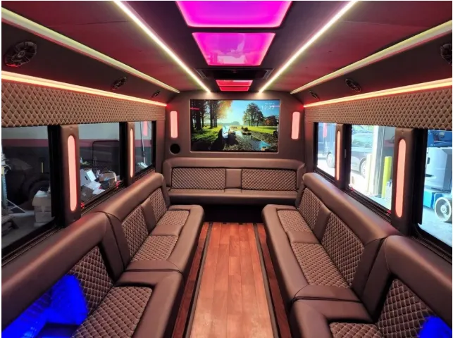 Limousine Bus interior with perimeter lounge seating, LED accent lighting and LED ceiling lighting, photo 2 for party bus rental