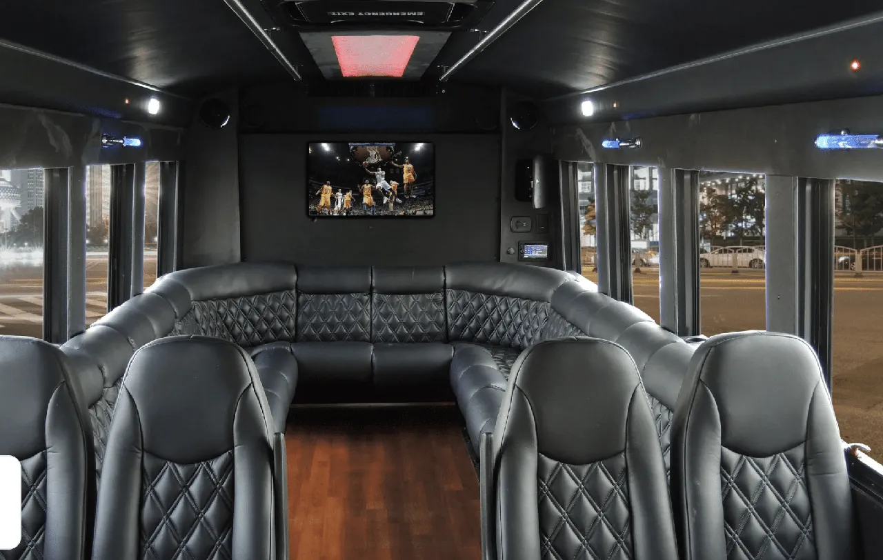 Limousine Coach Limousine Coach interior with perimeter lounge seating, sofa-style seating and wood-look flooring for party bus rental