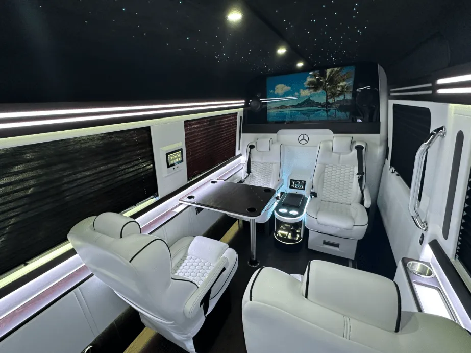 Luxury Mercedes-Benz Sprinter interior with captain's chairs, passenger tables and window shades, photo 2 for minibus rental