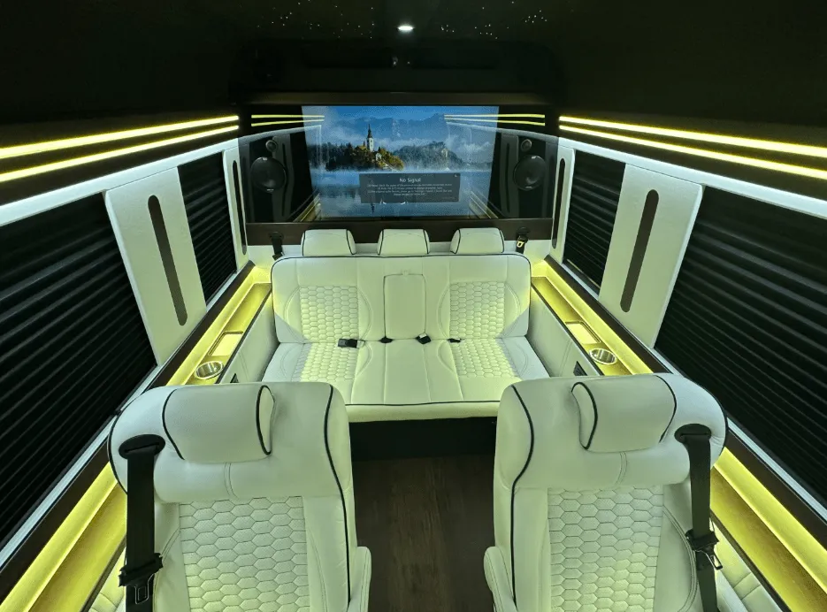 Luxury Mercedes-Benz Sprinter interior with captain's chairs, window shades and LED accent lighting for minibus rental