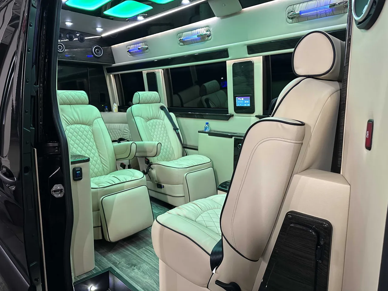 Mercedes-Benz Executive Sprinter Mercedes-Benz Executive Sprinter interior with captain's chairs, LED accent lighting and LED ceiling lighting for minibus rental