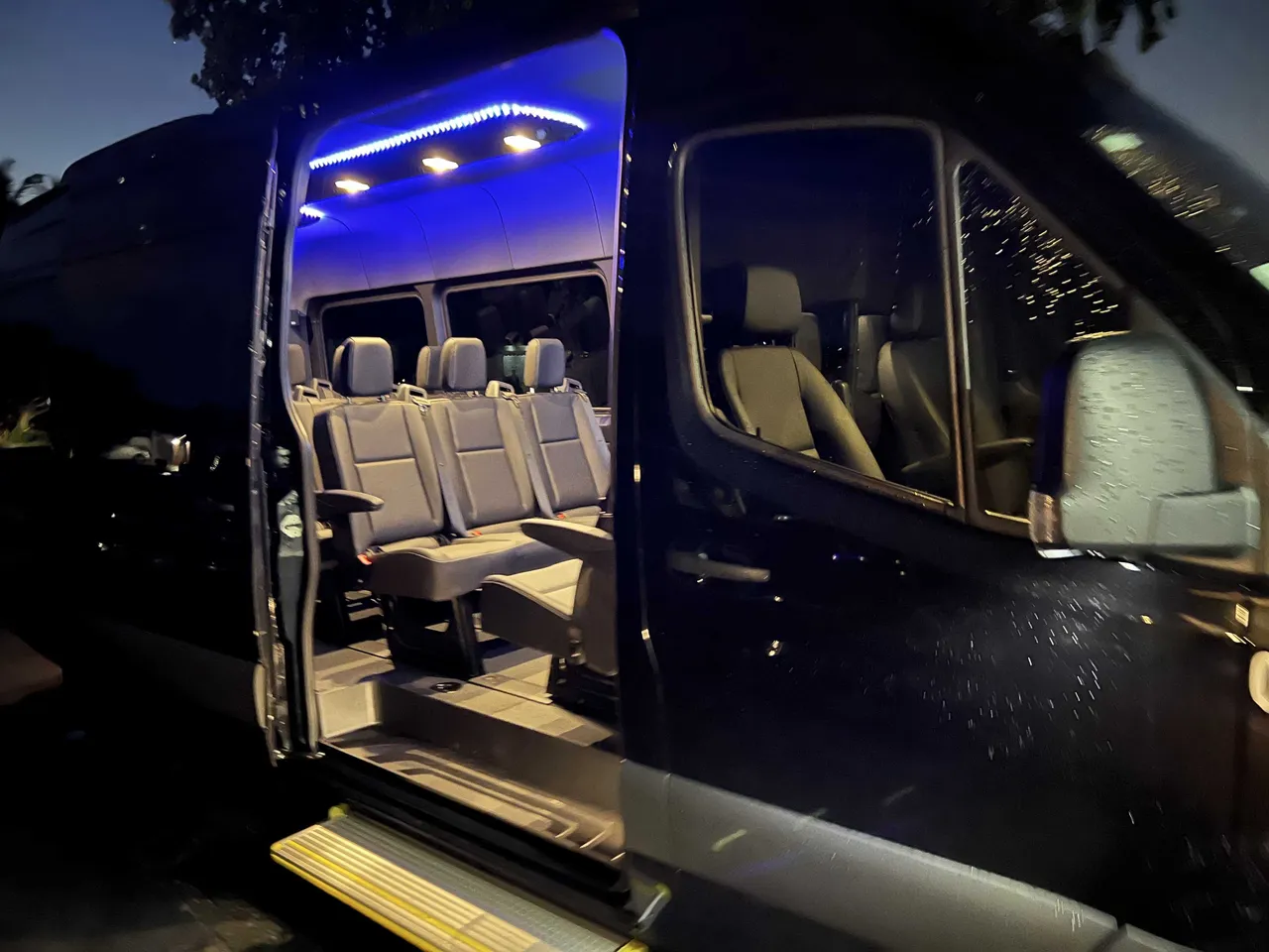 Mercedes-Benz Executive Sprinter interior with LED accent lighting and running boards for minibus rental