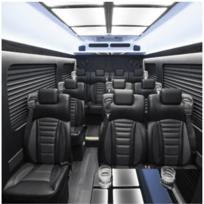 Mercedes Executive Sprinter interior with captain's chairs, passenger tables and window shades for minibus rental