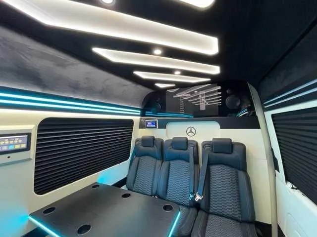 Mercedes-Benz Executive Sprinter interior with passenger tables, cup holders and window shades for minibus rental