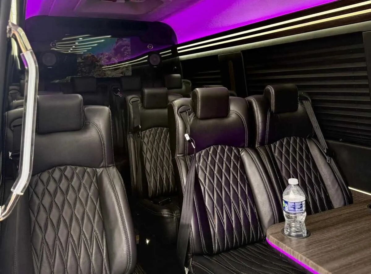 Mercedes-Benz Executive Sprinter Mercedes-Benz Executive Sprinter interior with captain's chairs, passenger tables and window shades for minibus rental