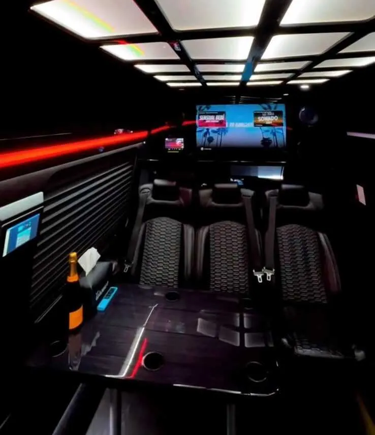 Mercedes-Benz Executive Sprinter interior with passenger tables, cup holders and window shades for minibus rental