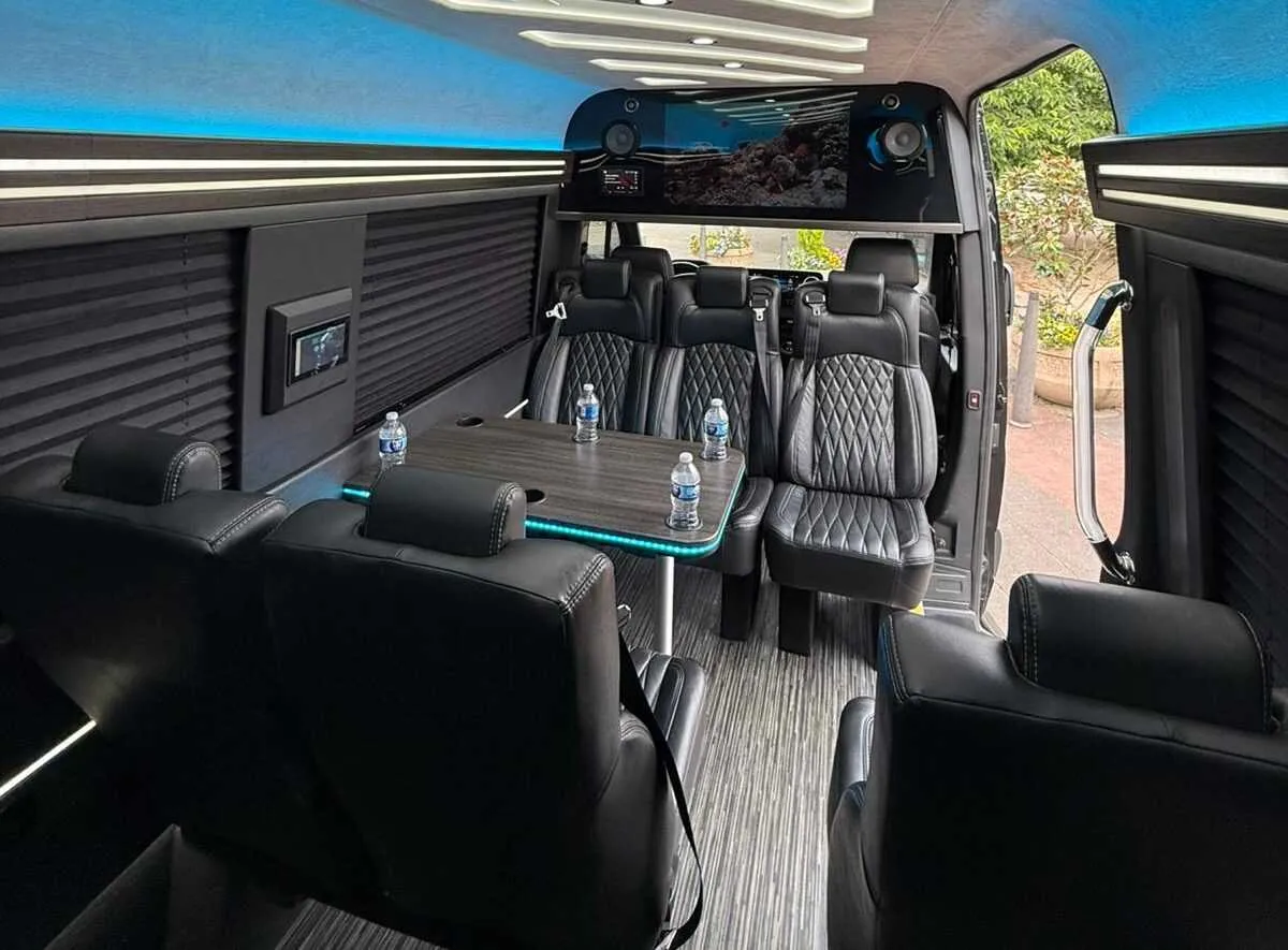 Mercedes-Benz Executive Sprinter interior with captain's chairs, passenger tables and window shades, photo 2 for minibus rental