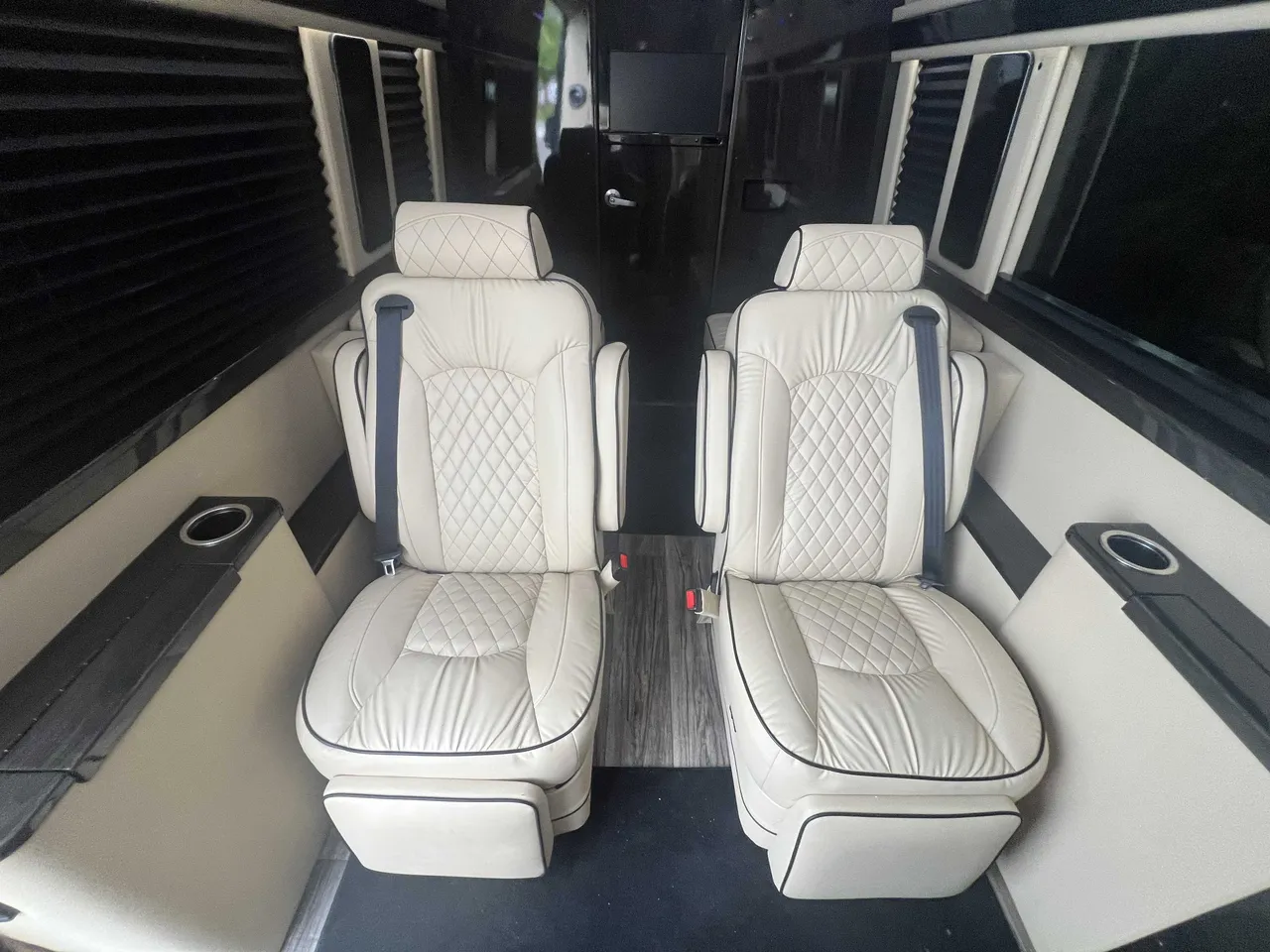Mercedes Executive Sprinter interior with captain's chairs and window shades for minibus rental