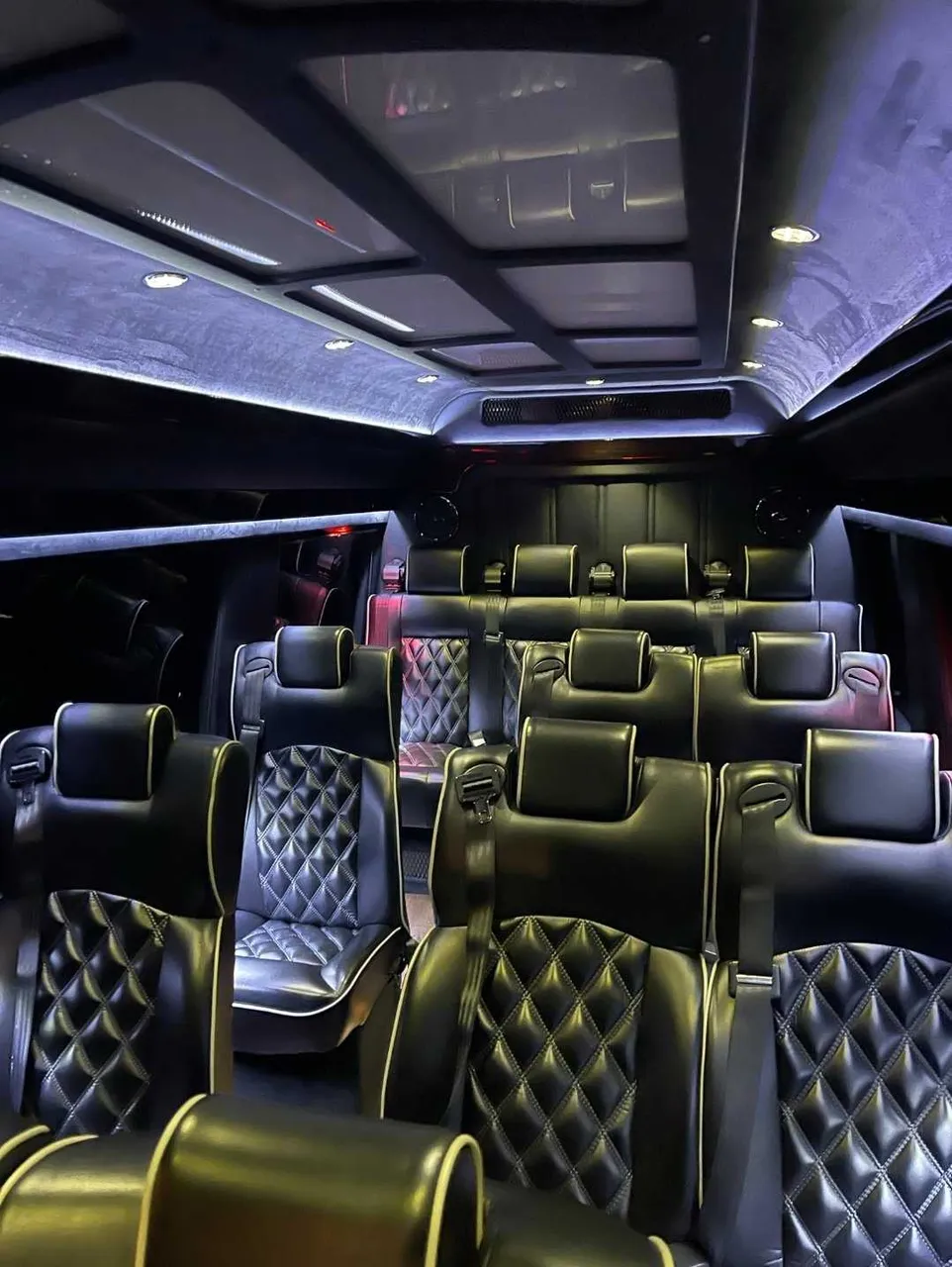 Mercedes-Benz Executive Sprinter interior with captain's chairs and LED ceiling lighting for minibus rental