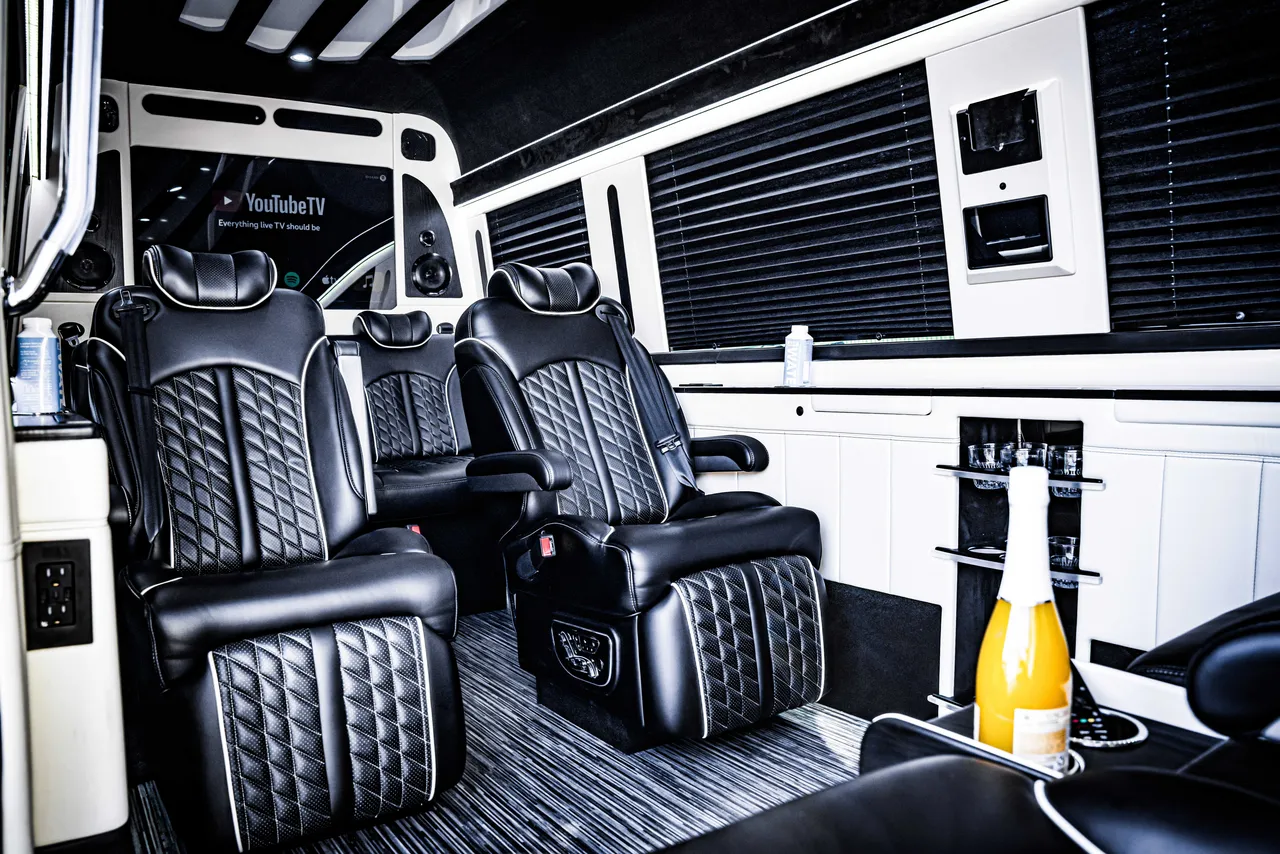 Mercedes-Benz Jet Sprinter Mercedes-Benz Jet Sprinter interior with captain's chairs, window shades and TV screens for minibus rental