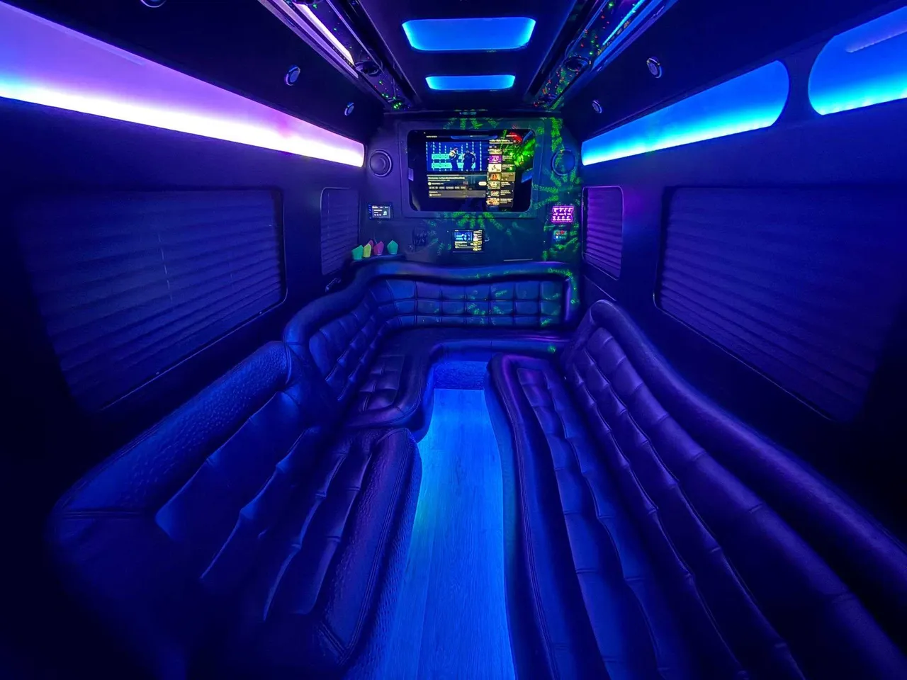 Mercedes-Benz Limousine Sprinter interior with perimeter lounge seating, window shades and LED accent lighting for party bus rental