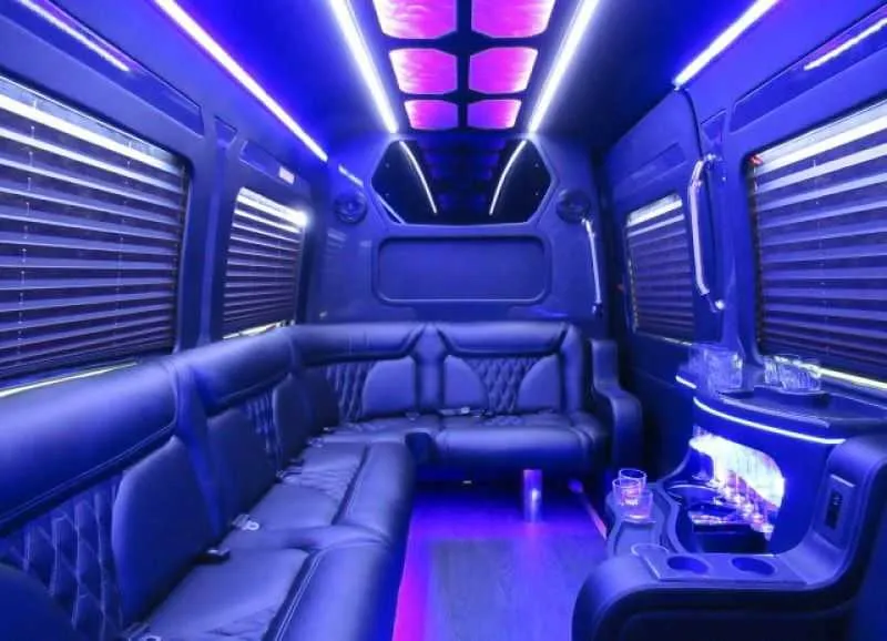 Mercedes-Benz Limousine Sprinter interior with perimeter lounge seating, window shades and LED accent lighting for party bus rental