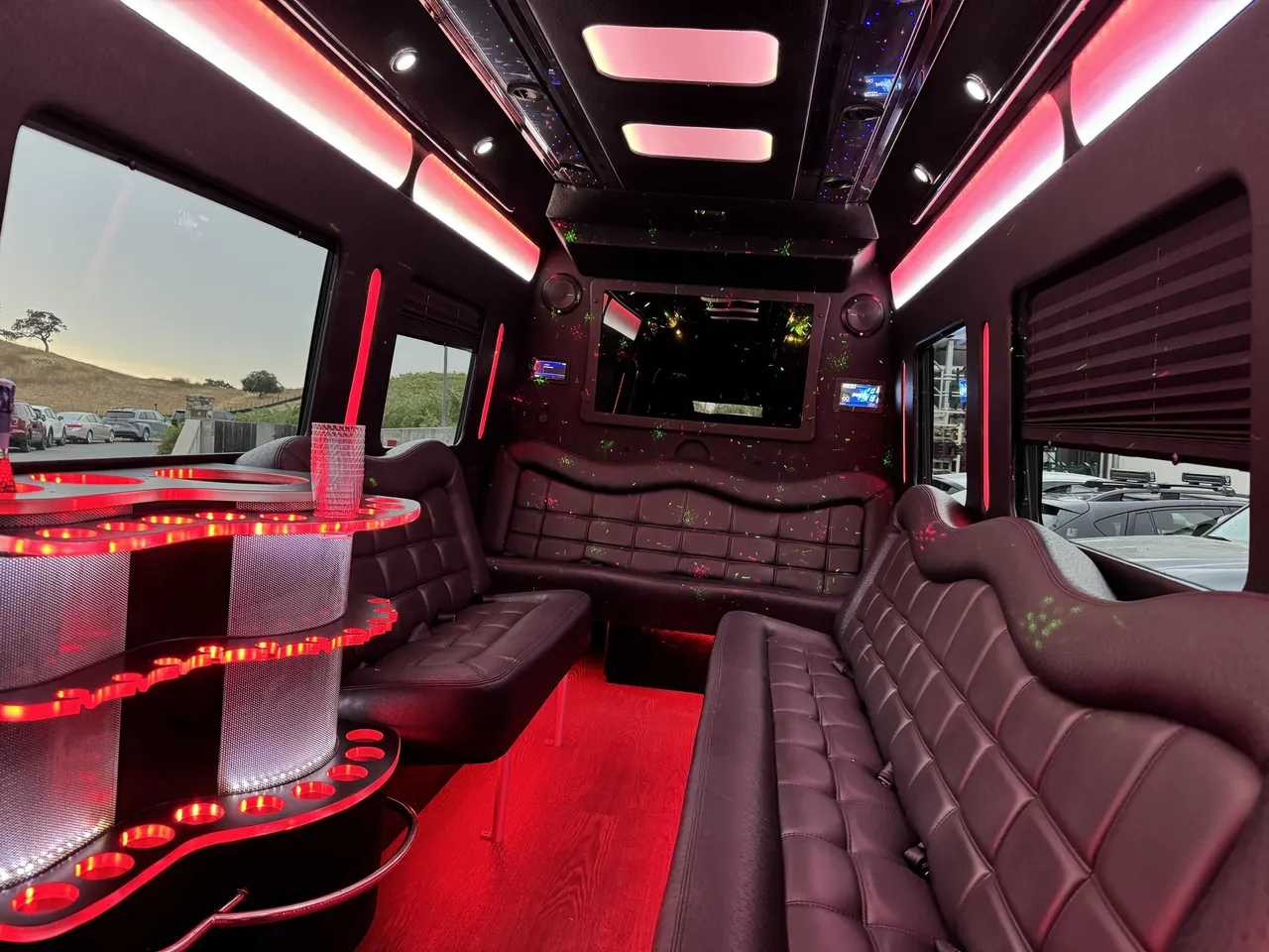Mercedes-Benz Party Bus interior with perimeter lounge seating, window shades and LED accent lighting, photo 6 for party bus rental