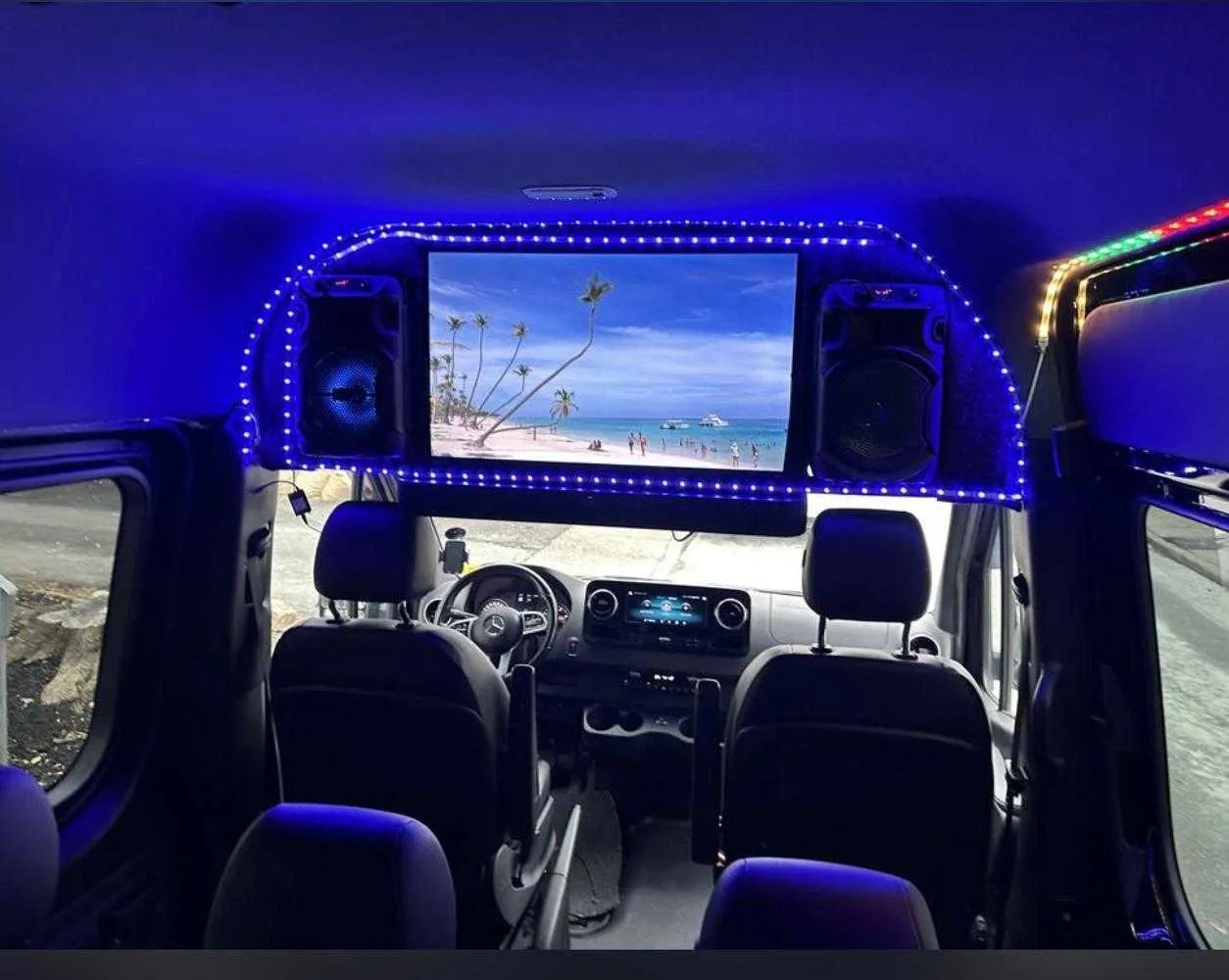 Mercedes-Benz Sprinter Mercedes-Benz Sprinter interior with LED accent lighting and TV screens for minibus rental