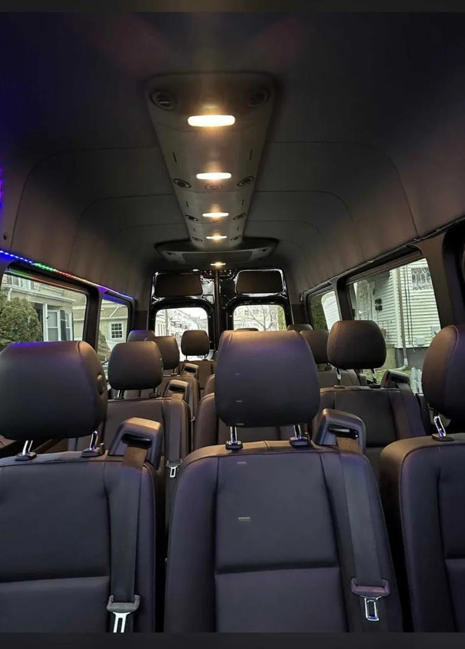Mercedes-Benz Sprinter interior with LED accent lighting and passenger seat belts for minibus rental