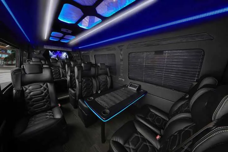 Mercedes-Benz Sprinter Executive Shuttle interior with captain's chairs, passenger tables and cup holders for minibus rental