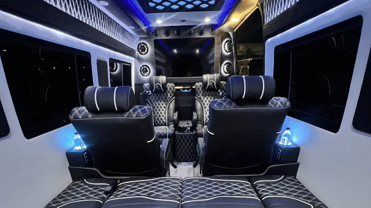 Mercedes-Benz Sprinter Jet interior with captain's chairs, cup holders and LED ceiling lighting for minibus rental
