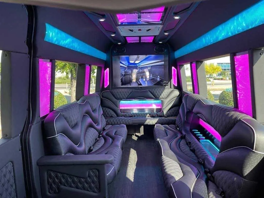 Mercedes-Benz Sprinter Limousine interior with sofa-style seating, LED accent lighting and LED ceiling lighting for party bus rental
