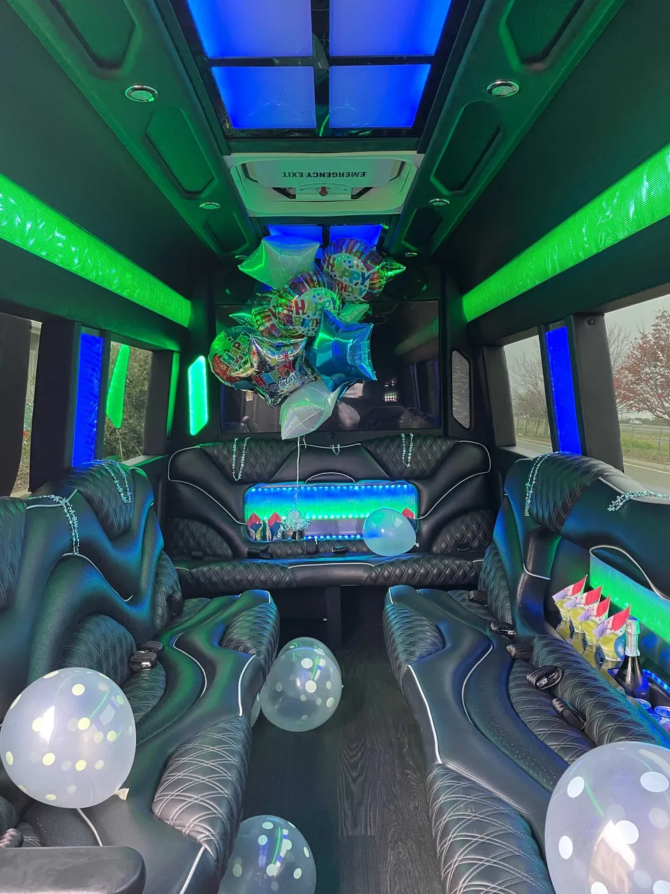 Mercedes-Benz Sprinter Limousine interior with perimeter lounge seating, LED accent lighting and LED ceiling lighting for party bus rental