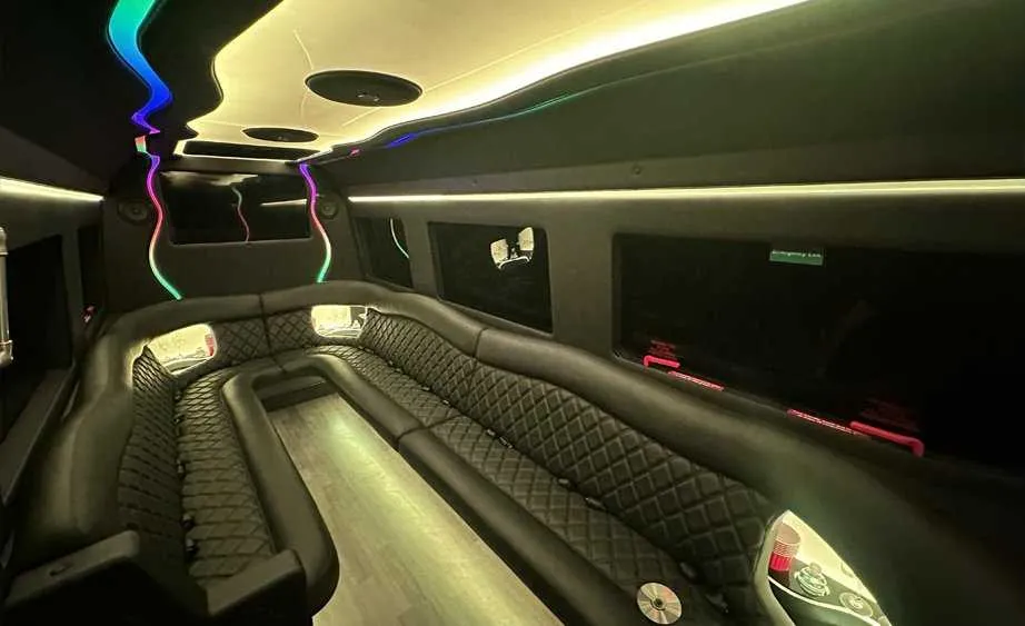Mercedes-Benz Sprinter Limousine interior with perimeter lounge seating, LED accent lighting and bar area for party bus rental