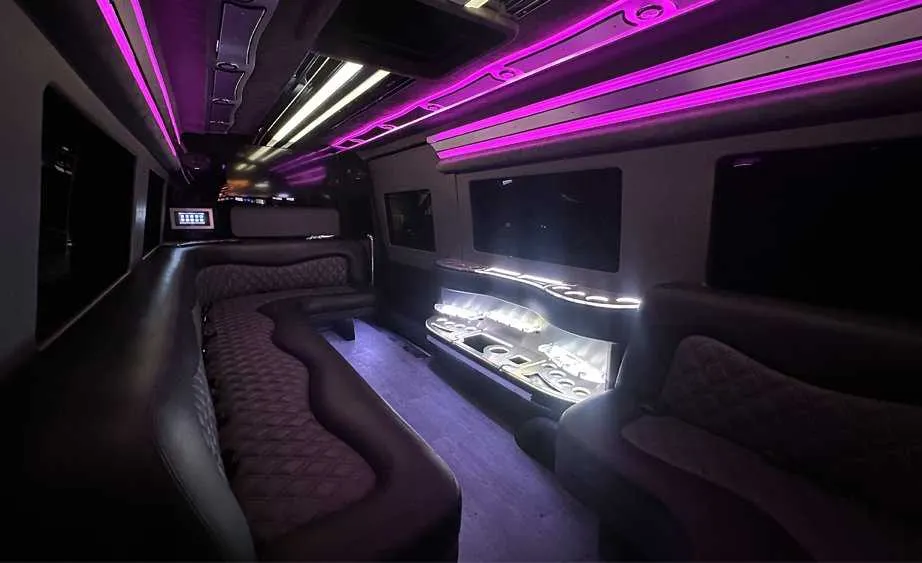 Mercedes-Benz Sprinter Limousine interior with perimeter lounge seating, LED accent lighting and bar area, photo 3 for party bus rental