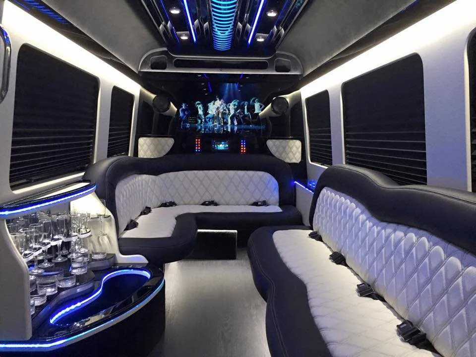 Mercedes-Benz Sprinter Limousine Mercedes-Benz Sprinter Limousine interior with perimeter lounge seating, sofa-style seating and window shades for party bus rental