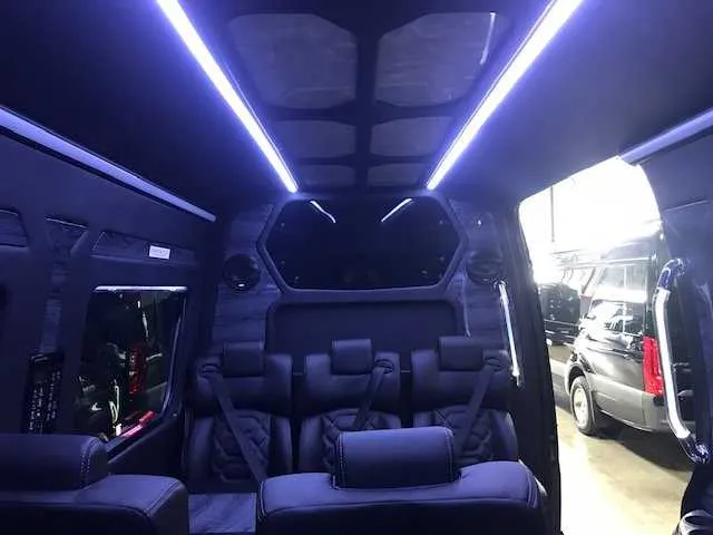 11 Passenger Mercedes-Benz Sprinter Luxury interior with LED ceiling lighting and grab handles and rails for minibus rental