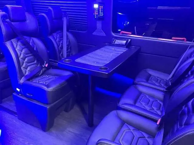 11 Passenger Mercedes-Benz Sprinter Luxury interior with captain's chairs, passenger tables and cup holders for minibus rental