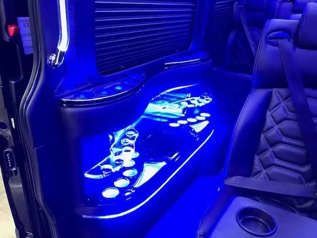 11 Passenger Mercedes-Benz Sprinter Luxury interior with captain's chairs, cup holders and window shades for minibus rental