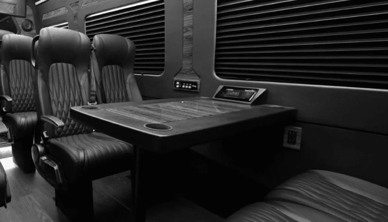 Mercedes-Benz Sprinter Van interior with captain's chairs, passenger tables and cup holders for minibus rental