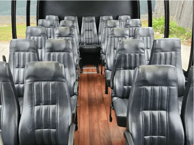 24 Passenger Mini Bus interior with wood-look flooring for minibus rental