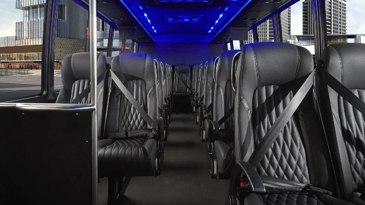 28 Passenger Mini Coach interior with LED ceiling lighting and passenger seat belts for minibus rental