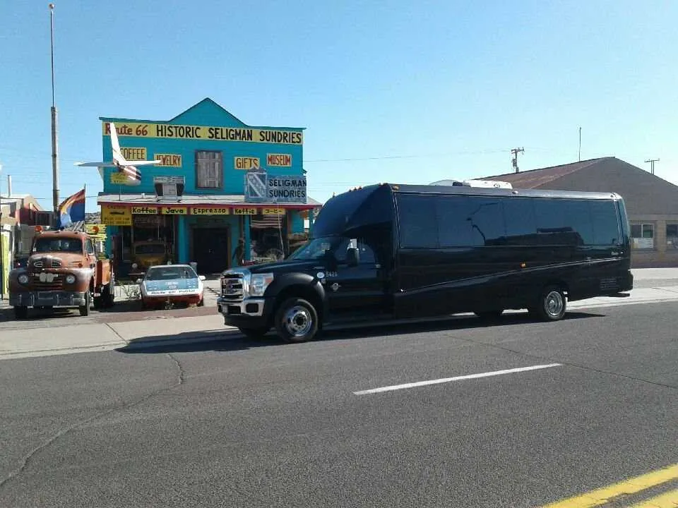 Black 28 Passenger Mini Coach with tinted windows for minibus rental