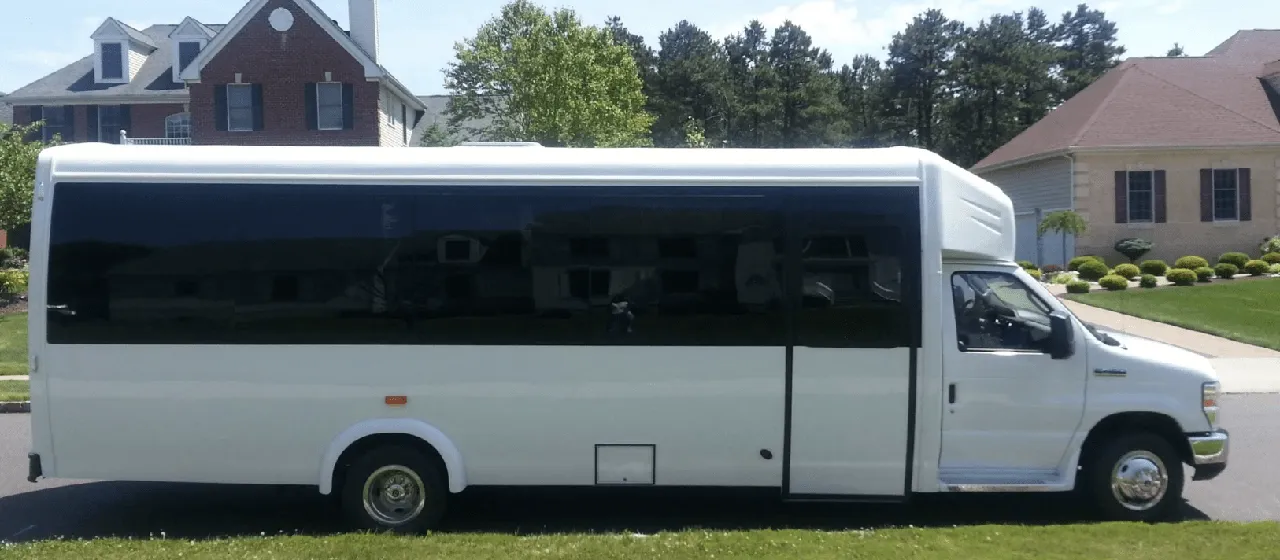 32 Passenger Mini Coach White 32 Passenger Mini Coach with tinted windows for minibus rental